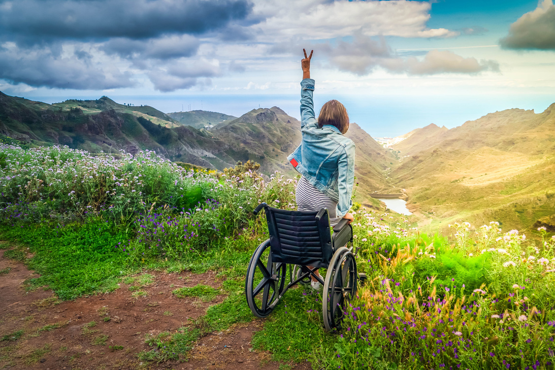 Disabled  Woman in Wheelchair on Mountain Hill Enjoying View